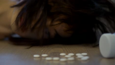 woman lying on floor after taking drugs