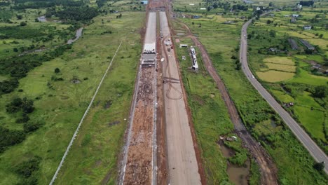 Aerial-view-of-the-Samruddhi-Mahamarg-or-Nagpur-to-Mumbai-Super-Communication-Expressway-under-construction,-the-six-lane-highway-passes-through-many-mountains-and-agricultural-lands