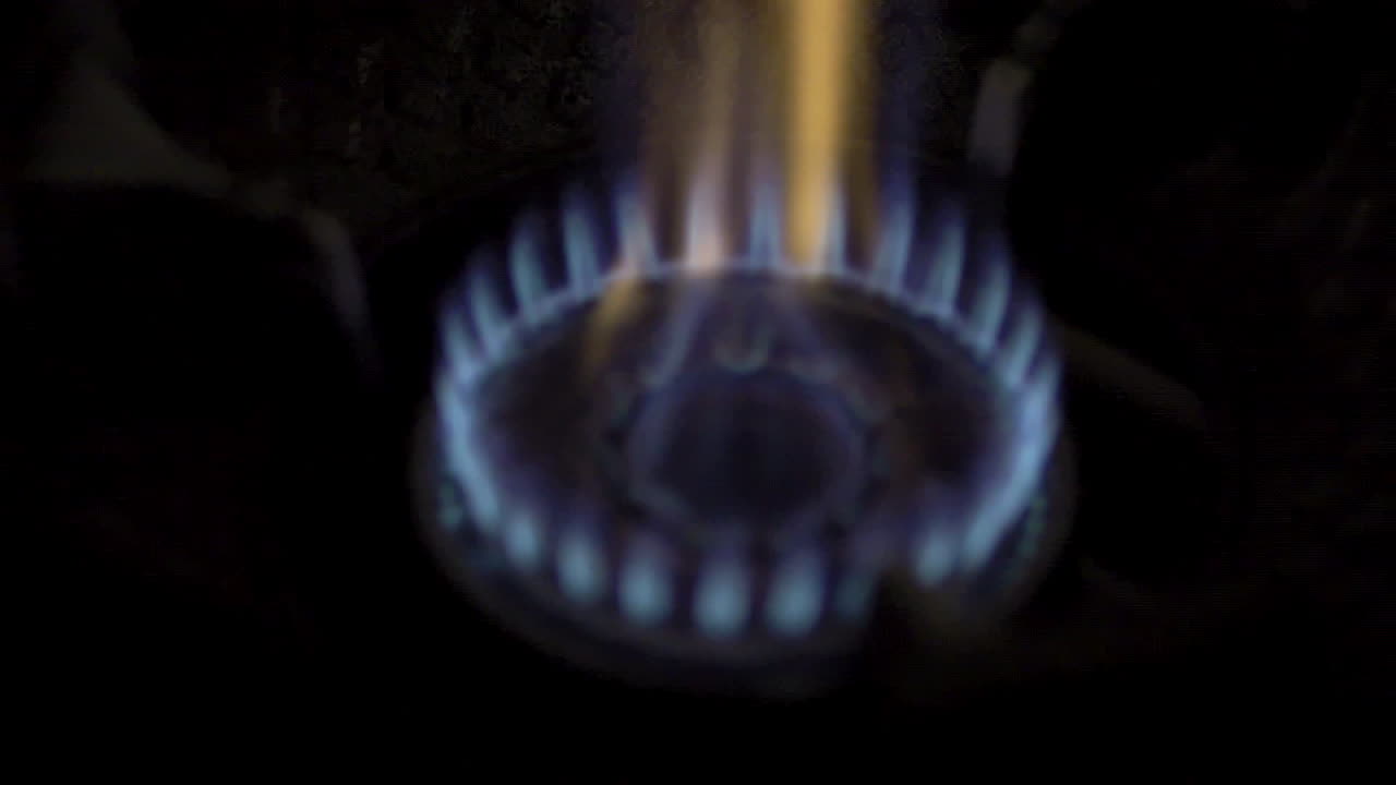 Slow Motion Blue Flames from Kitchen Gas Stove, High Heat Cooking for Enhanced Flavor and Aroma in Culinary Preparation.