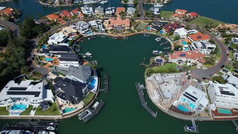 aerial shot over luxury homes in sovereign islands in paradise point, gold coast, queensland, australia