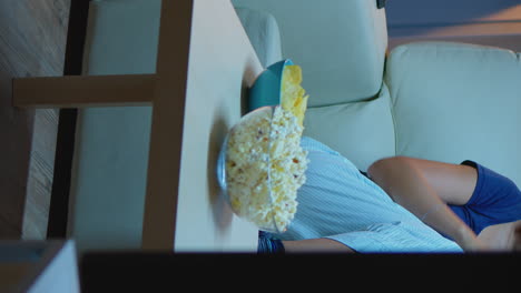 vertical video: housewife relaxing at comedy tv show