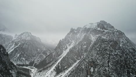aerial view of snow-covered mountain range and clouds