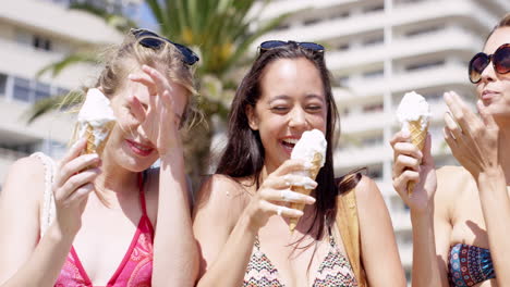 close up portrait teenage girls eating ice cream in the summer on vacation