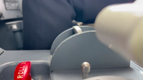 Close-up-view-of-the-hand-of-a-white-pilot-inside-the-cockpit-selecting-the-flap-lever-position