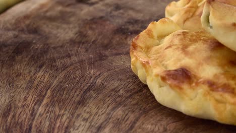 homemade empanadas on a rotating plate (seamless loopable)