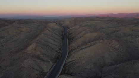 Aerial-View-Of-Purple-Sky-Sunset-On-Horizon-Over-RCD-Road-Through-Remote-Balochistan