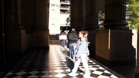 pedestrians walking near the library entrance