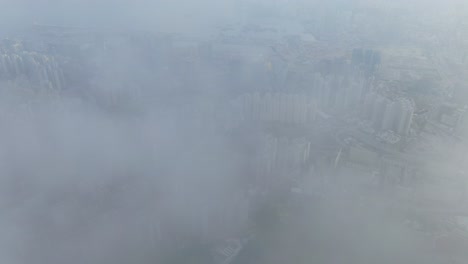 hong kong bay and skyline with skyscrapers, high altitude wide shot with early morning mist