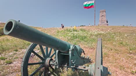 old cannon at shipka pass monument with bulgarian flag