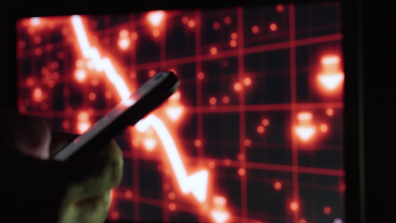 A hand holds a smartphone in focus with AI stock charts in the background. Concept of trading, fintech, and digital markets