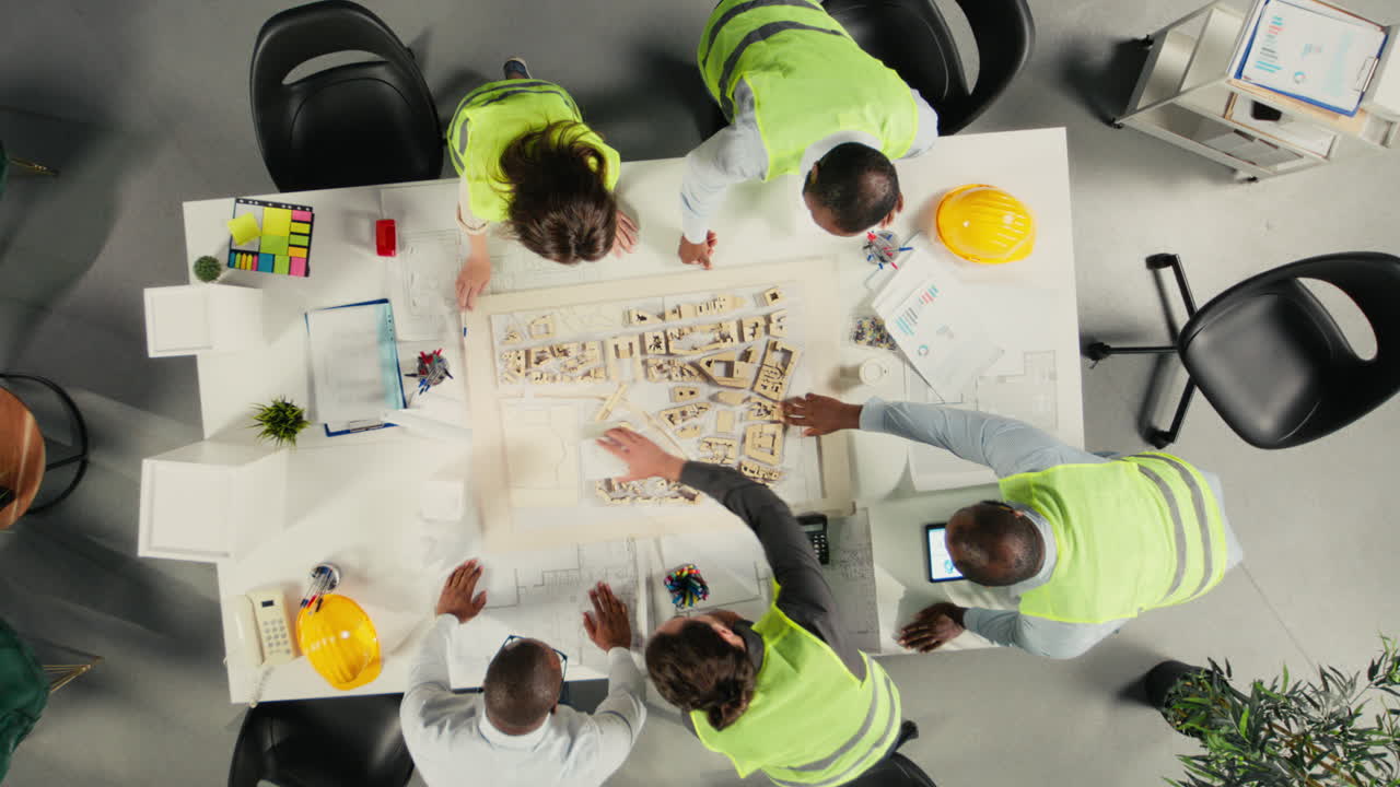 Vertical Video Top down view zoom in of real estate professionals using architectural software