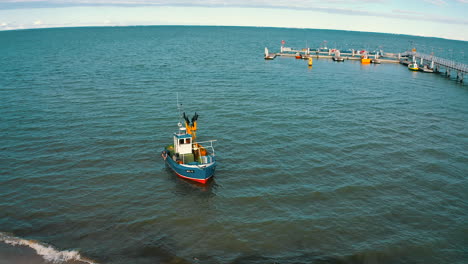 Aerial-view-of-fishing-boat-slowly-going-towards-the-sea