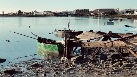 fixed shot of fishing boat anchored on river bay, barbate, spain