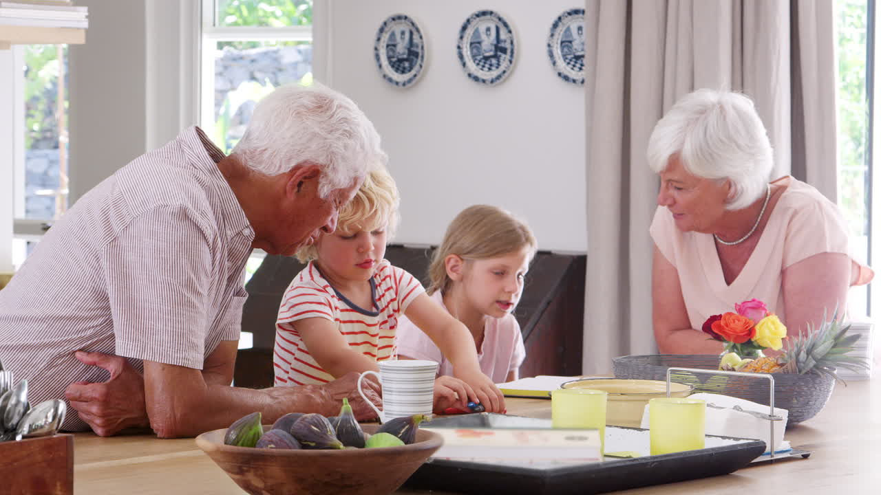Grandparents and grandkids talking in the kitchen, close up