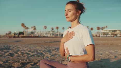 caucasian woman meditating by the sea.