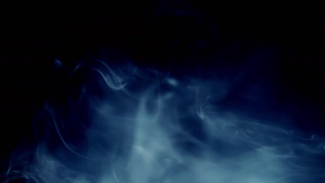 light blue-tinted smoke enters frame from left and dissipates for long time on black background for overlay.