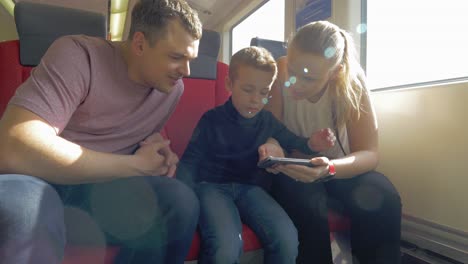 view of happy family in the railway trip using smartphone prague czech republic