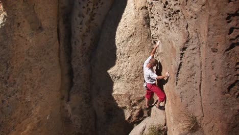 a man climbs a rock face