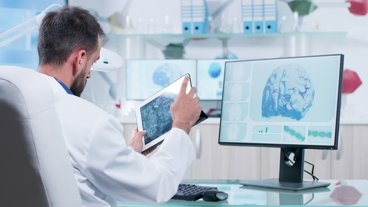 Doctor analyzing brain scans on a tablet and monitor in a modern lab