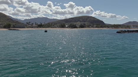 Low-angle-view-of-Pokai-beach-skimming-across-the-shimmering-ocean