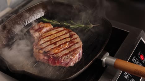 cooking a ribeye steak in a pan