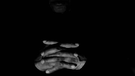 man praying to god caribbean man praying with hands together with people on gray black background stock video stock footage