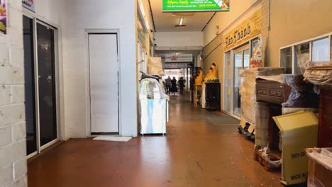 a bustling alleyway with shops and people