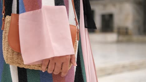 woman holding a straw bag