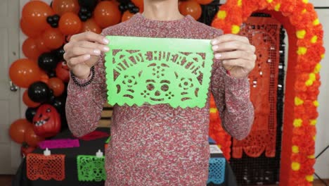 Green-handmade-Día-de-muertos-perforated-paper-with-macabre-picture