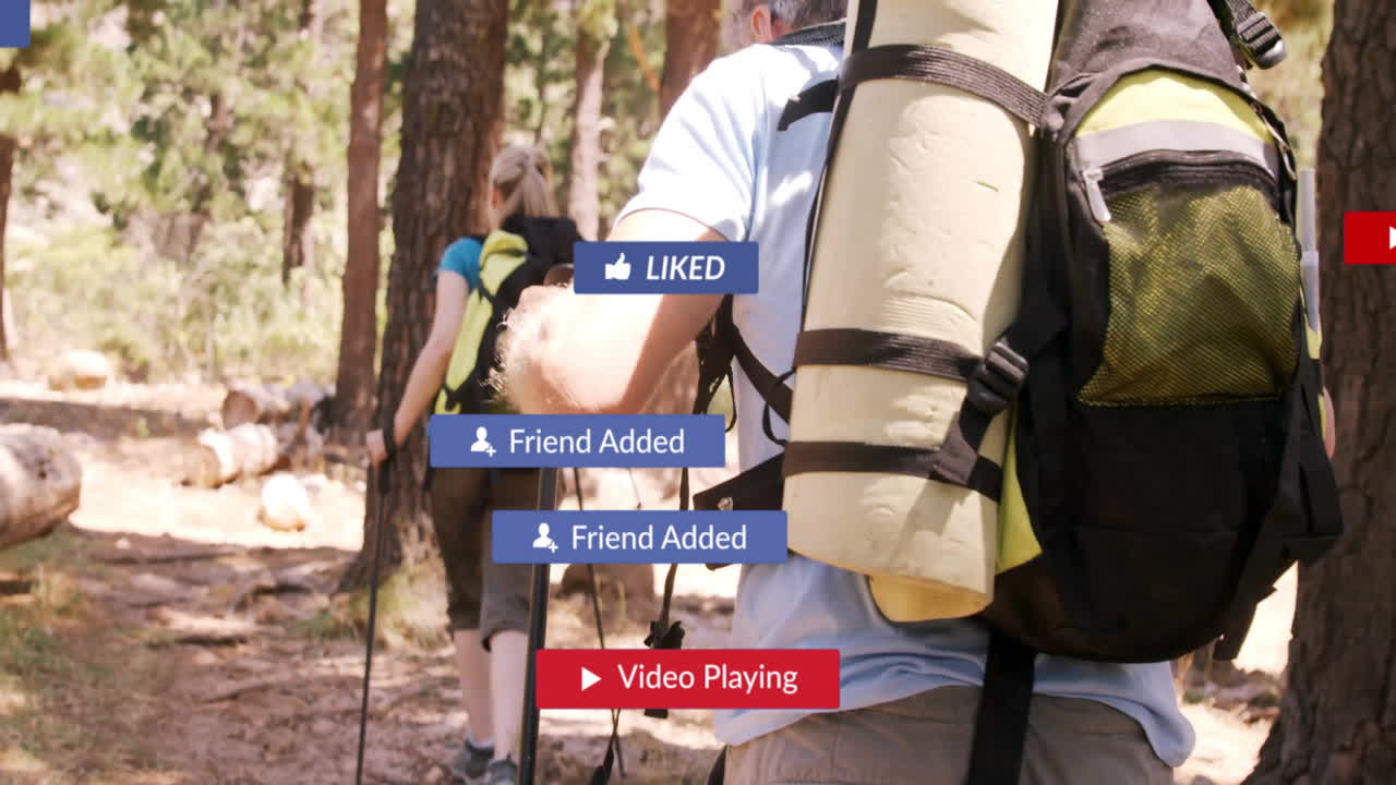 Mature couple hiking forest trail, overlaying floating social media notification graphics