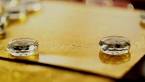 chinese tea set and glass chinese chess on the golden chess board