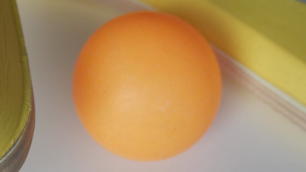 Beach tennis ball and racket in a close-up, sunny and playful mood