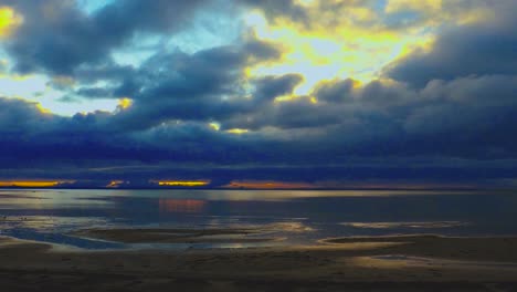 people walking on the beach during sunset