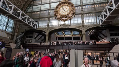 visitors observing art in a grand museum hall