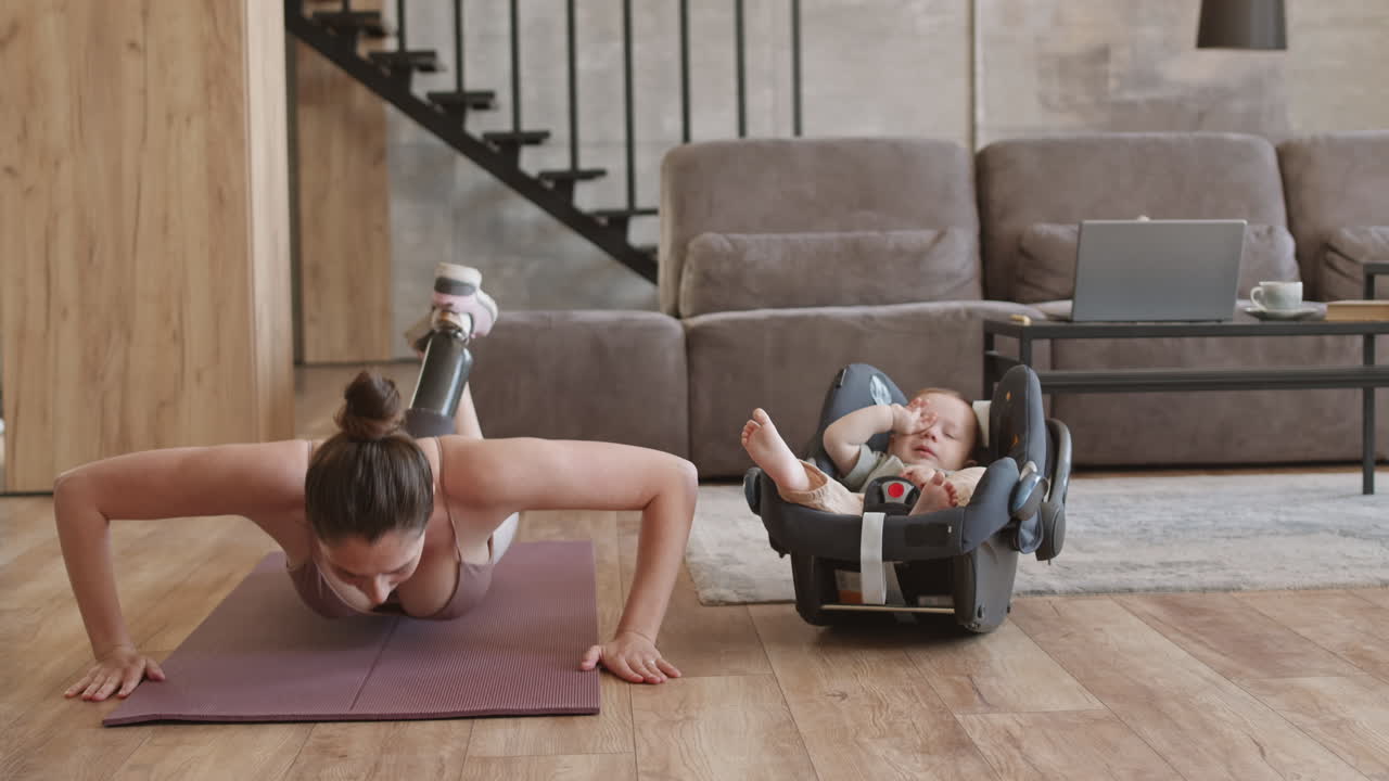 Sporty Woman with Disability Doing Exercises while Babysitting