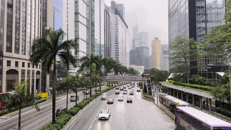 traffic driving on gloucester road in hong kong on a gloomy day