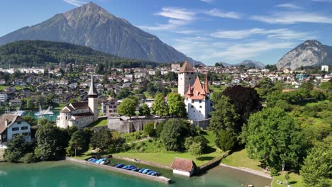 drone panoramic view of spiez church and castle on the shore of lake thun in the canton of bern, switzerland