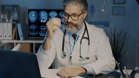 doctor reviewing medical records at night