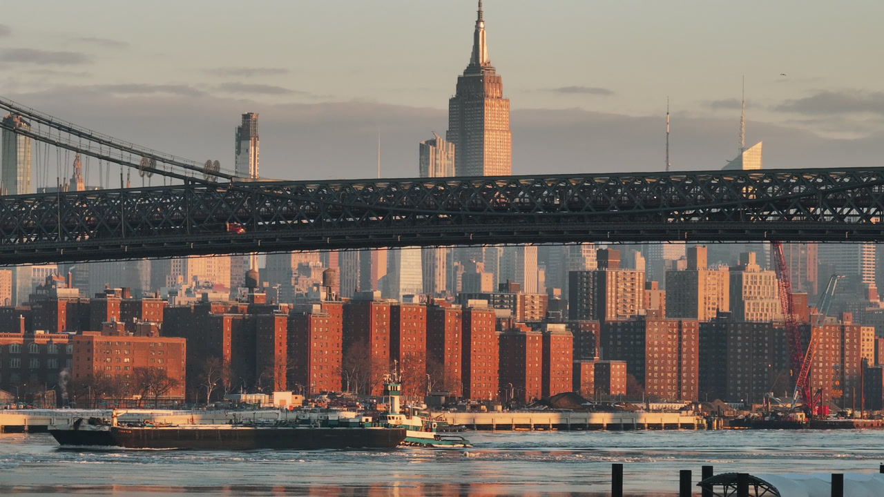 Aerial view of a freight ship on a frozen East River. Shot in New York City at sunrise.