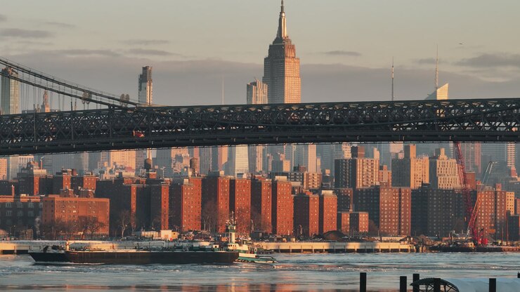 Aerial view of a freight ship on a frozen East River. Shot in New York City at sunrise.