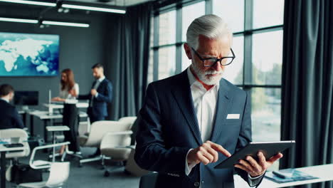 senior business man using tablet in modern office