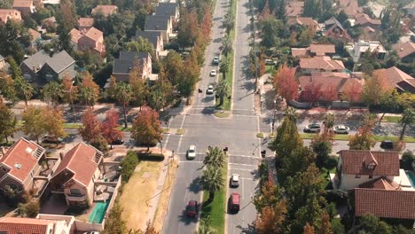 ascending aerial drone shot of intersection in residential area