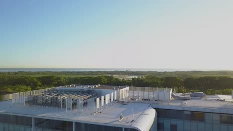 Aerial-revealing-La-Plata-River-and-Buenos-Aires-Ecological-reserve-behind-a-modern-building