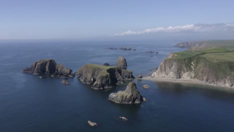 flat grassy plateau tops rugged rock islet off ocean cliffs of ireland