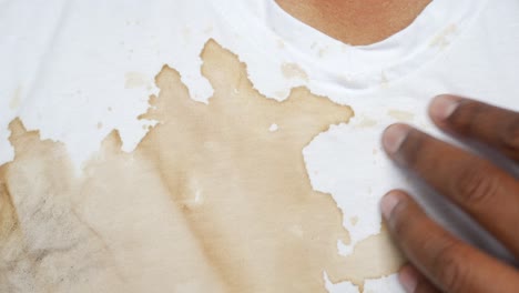 close-up of a coffee stain on a white shirt