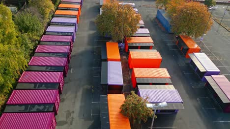 imágenes aéreas de portacabinas multicolores, puestos de mercado, cabinas de acero, unidades de almacenamiento, tomadas desde arriba y moviéndose lentamente hacia adelante