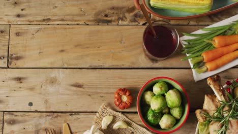 video of tray with corn, carrots and autumn vegetables on wooden surface