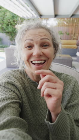 vertical video of senior caucasian woman having video call, slow motion