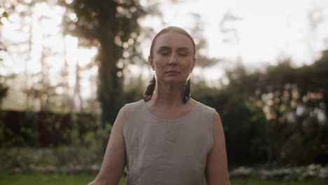 senior woman meditating in garden