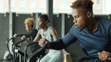 people exercising on exercise bikes in a gym